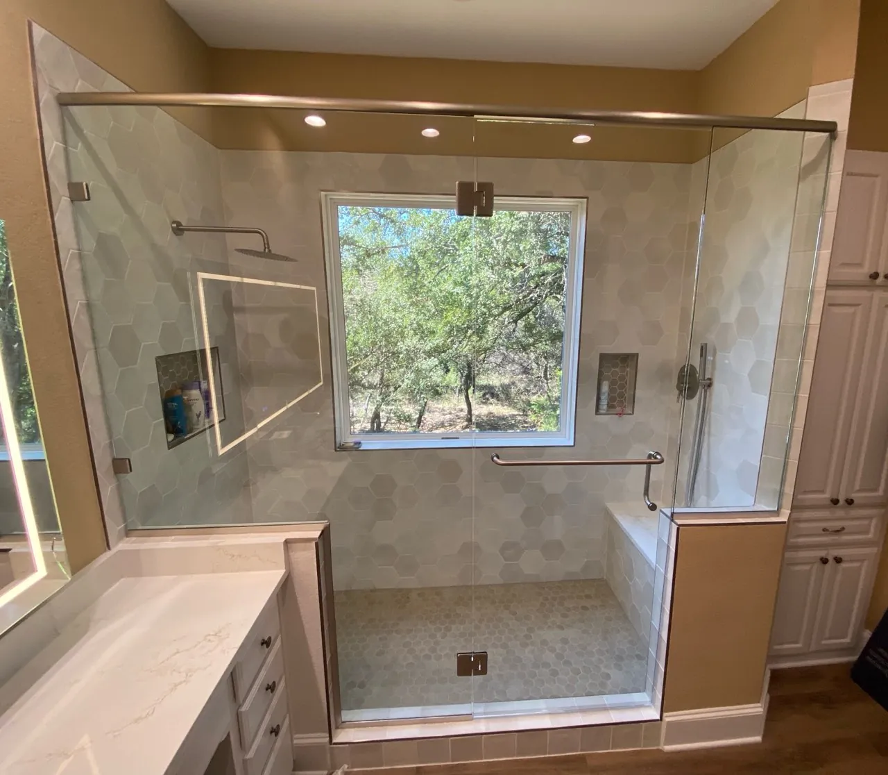 Frameless glass shower enclosure with clear glass and chrome hardware