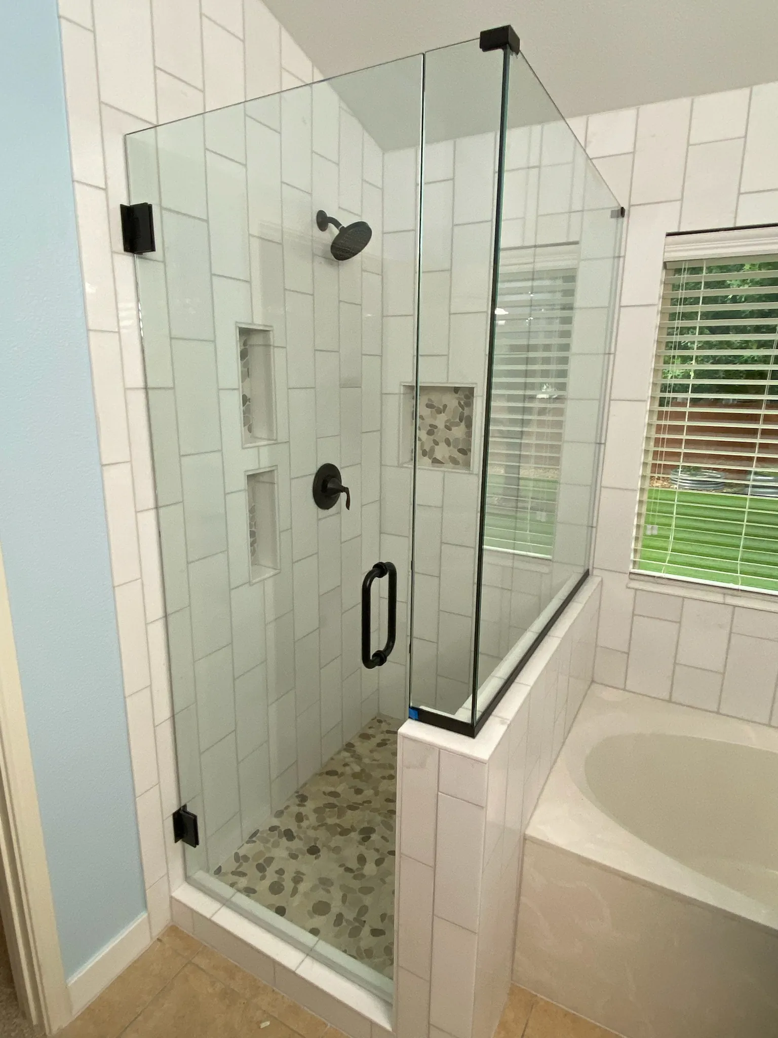 Frameless glass shower with tall ceiling panel