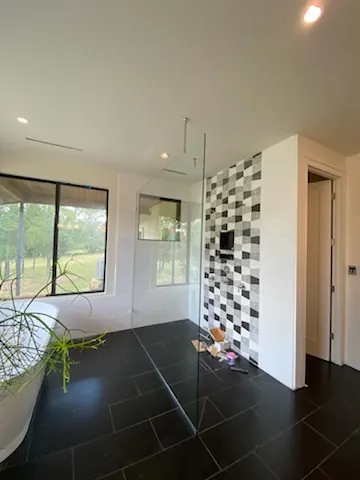 Frameless shower door with brushed nickel pull