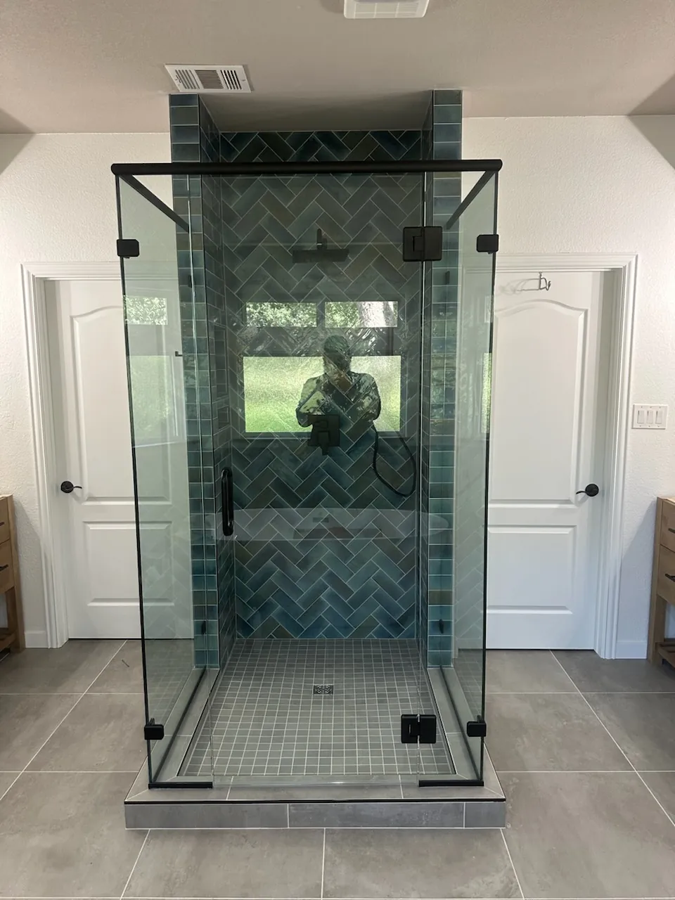 Frameless shower door on a tiled curb