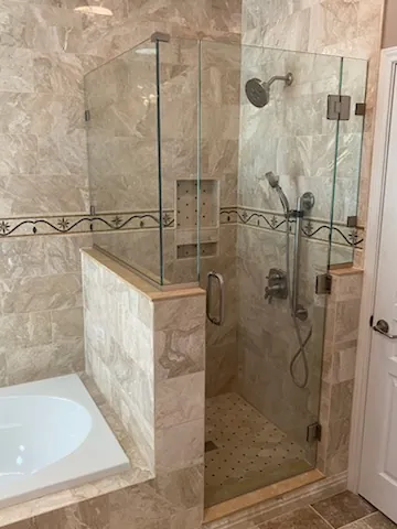 Frameless shower with a curbless entry
