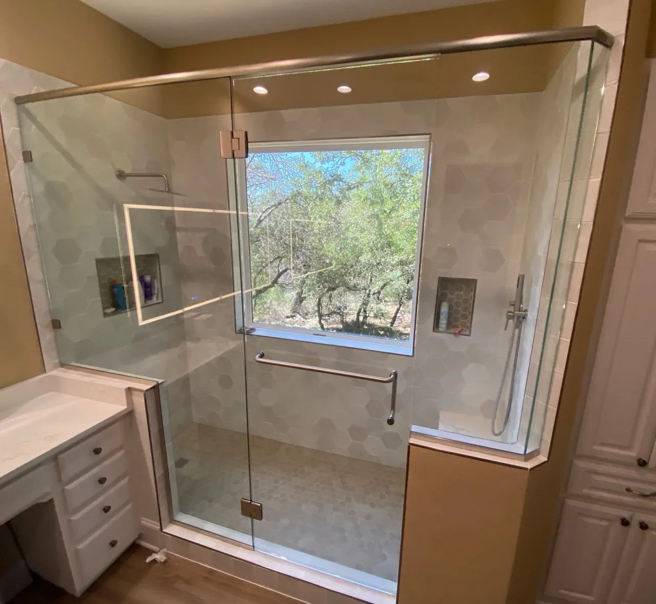 Walk-in frameless shower with a fixed glass panel