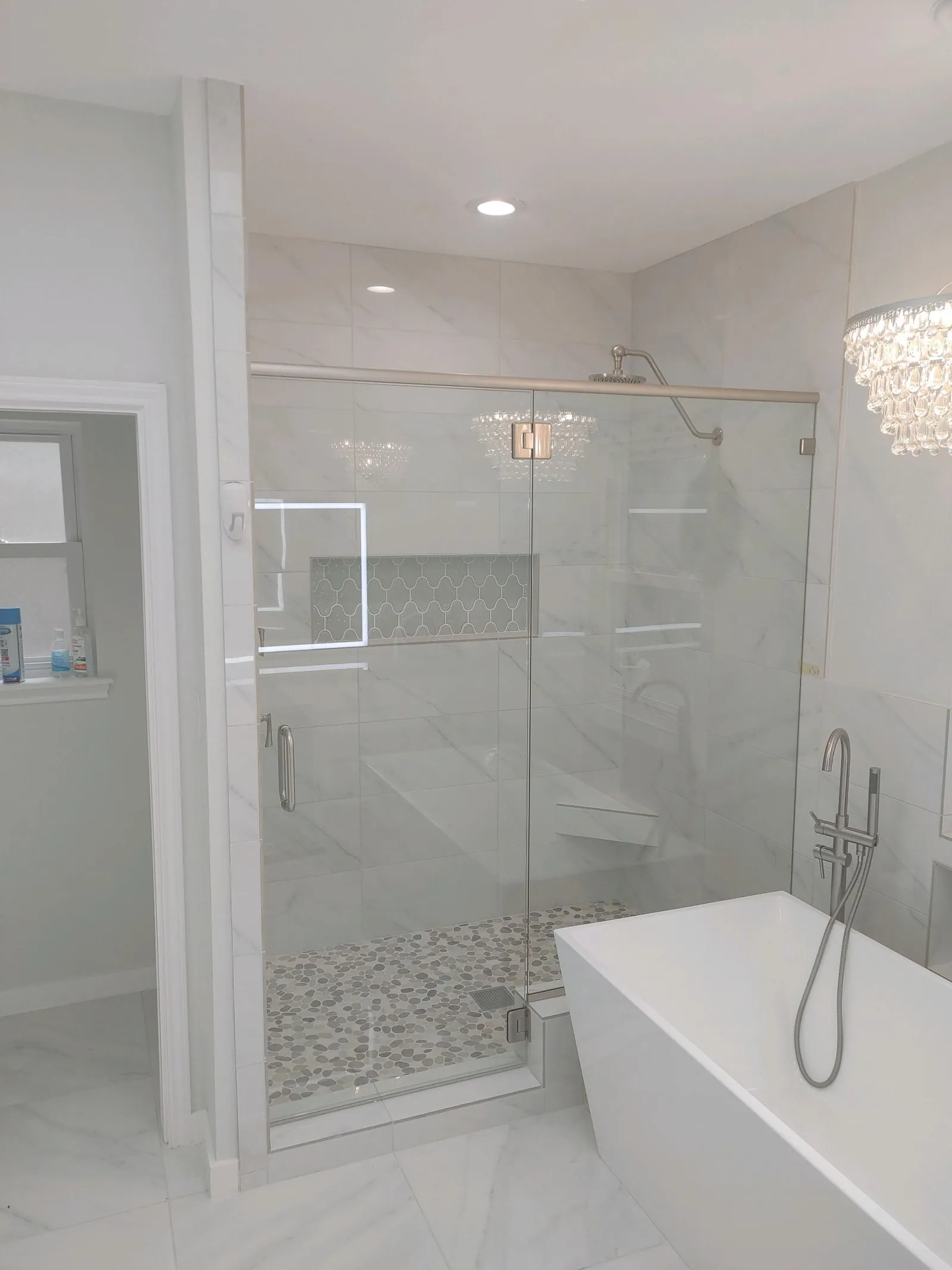 Frameless shower door installed against tile in a Georgetown, TX bathroom